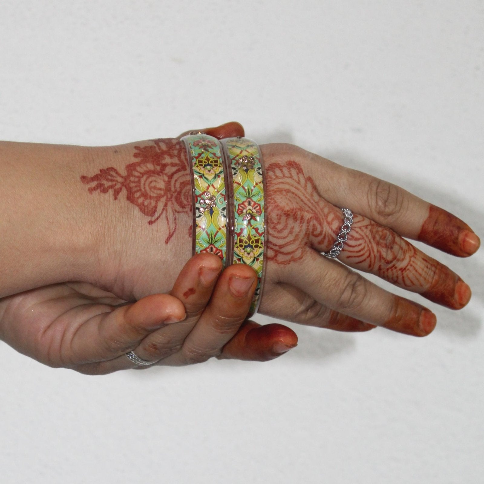 A hand wearing Handcrafted Floral Resin Bangle