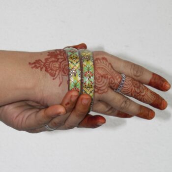A hand wearing Handcrafted Floral Resin Bangle
