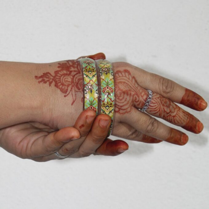 A hand wearing Handcrafted Floral Resin Bangle