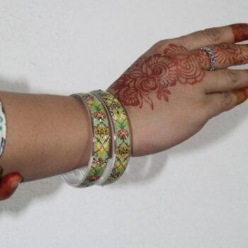 A model showing Handcrafted Floral Resin Bangles wearing in his hands