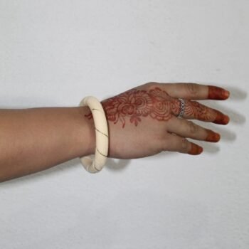 Elegant Ivory Bangle with Gold Accents in Hand Look