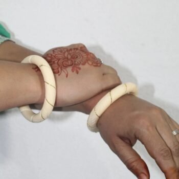 Elegant Ivory Bangle with Gold Accents in Hand