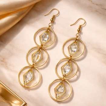 Stylish gold crystal drop earrings with soft luxury background, perfect for wedding and festive wear