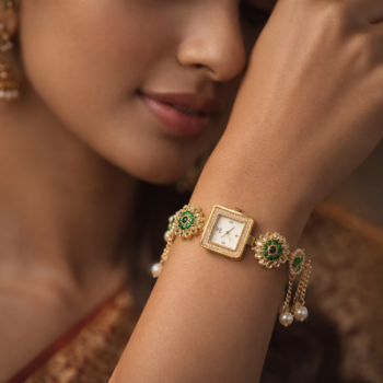 Woman wearing Kashmiri ethnic bracelet watch with green stones and pearl drops, traditional jewelry watch