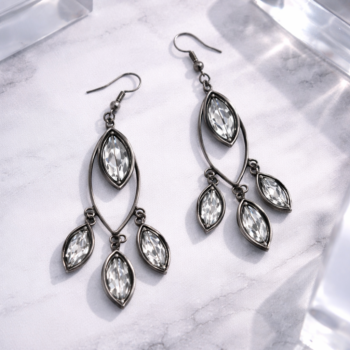 Premium gunmetal chandelier earrings with crystal stones on marble surface luxury jewelry
