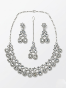 Silver bridal necklace set with crystal stones including earrings and maang tikka isolated on white background