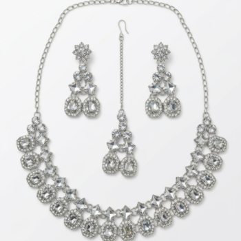 Silver bridal necklace set with crystal stones including earrings and maang tikka isolated on white background
