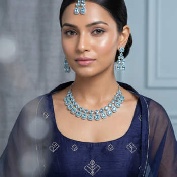 Woman wearing silver crystal necklace set with matching earrings and maang tikka in traditional outfit