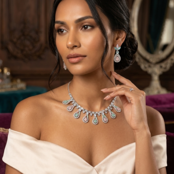 Woman wearing silver pastel necklace set with mint green and blush pink teardrop stones and matching earrings